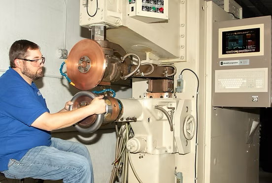 Technician grinding and finishing a turbine component